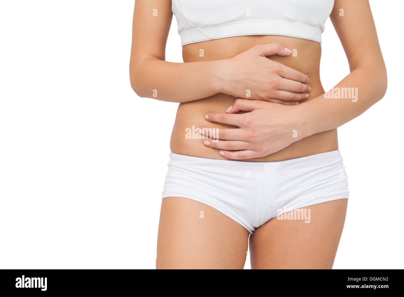 Young woman touching her belly with her hands Stock Photo
