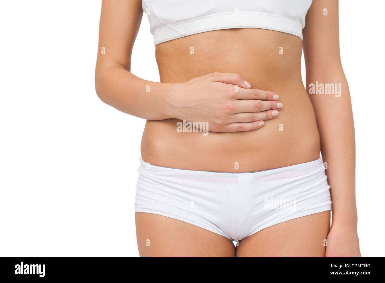 Mid section of slim woman touching her belly with one hand Stock Photo