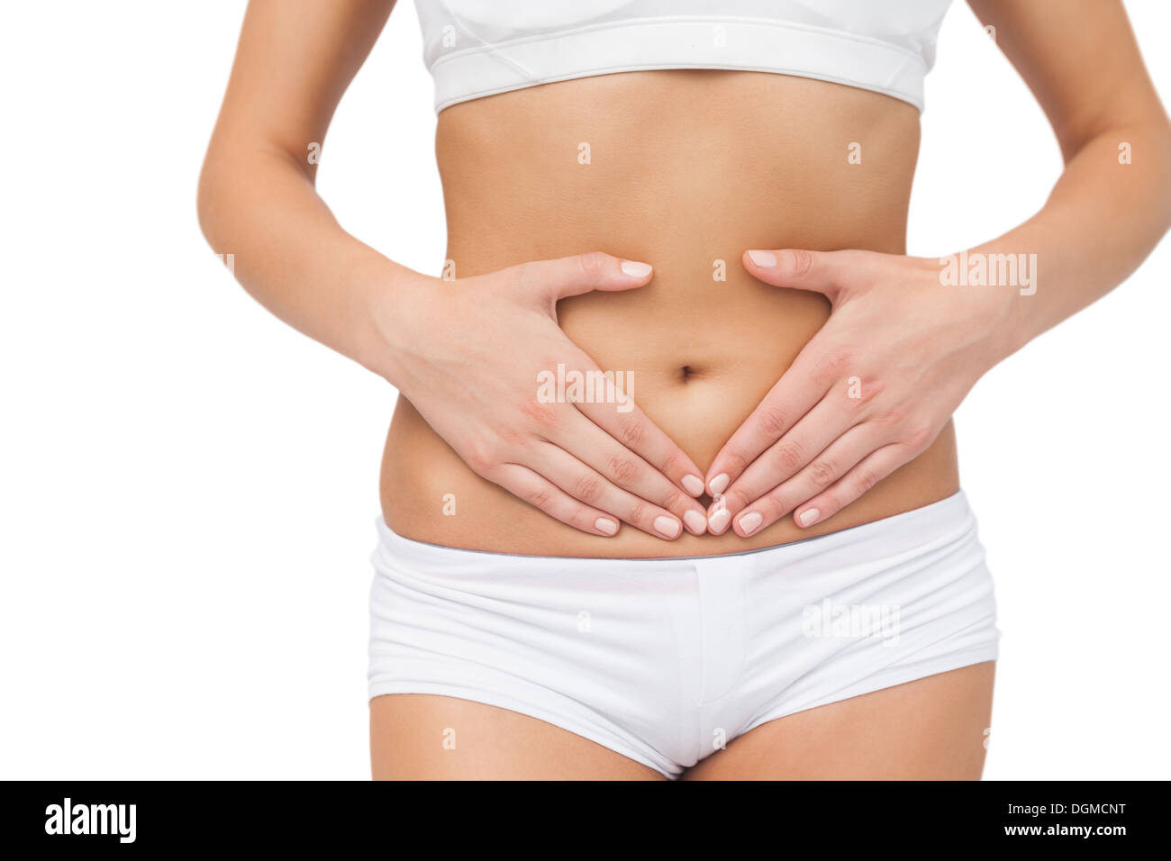 Mid section of slim woman touching her belly with her hands Stock Photo
