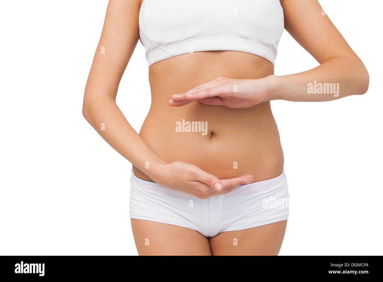 Slim woman wearing sports bra presenting with her hands Stock Photo