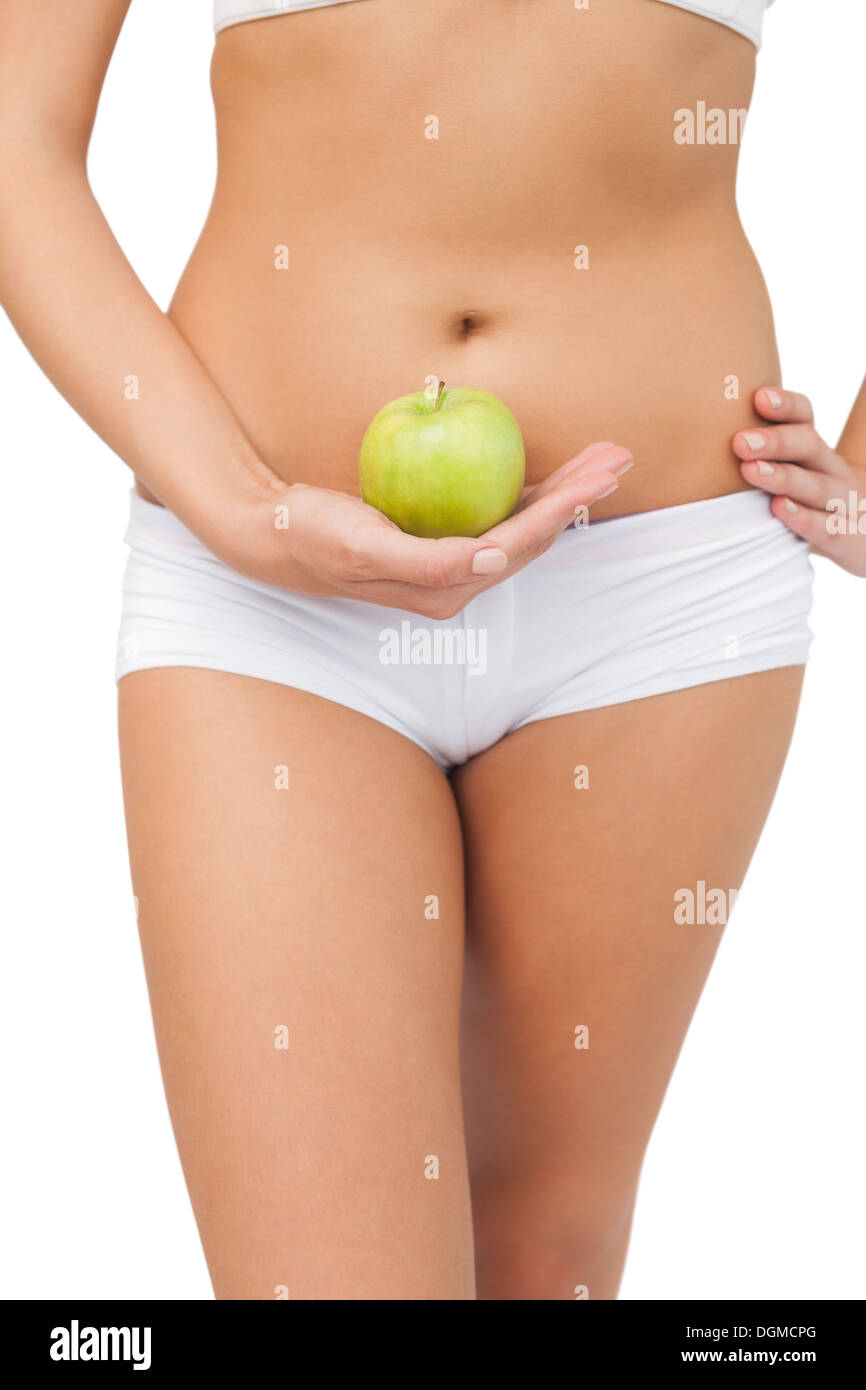 Close up of slim woman holding a green apple Stock Photo