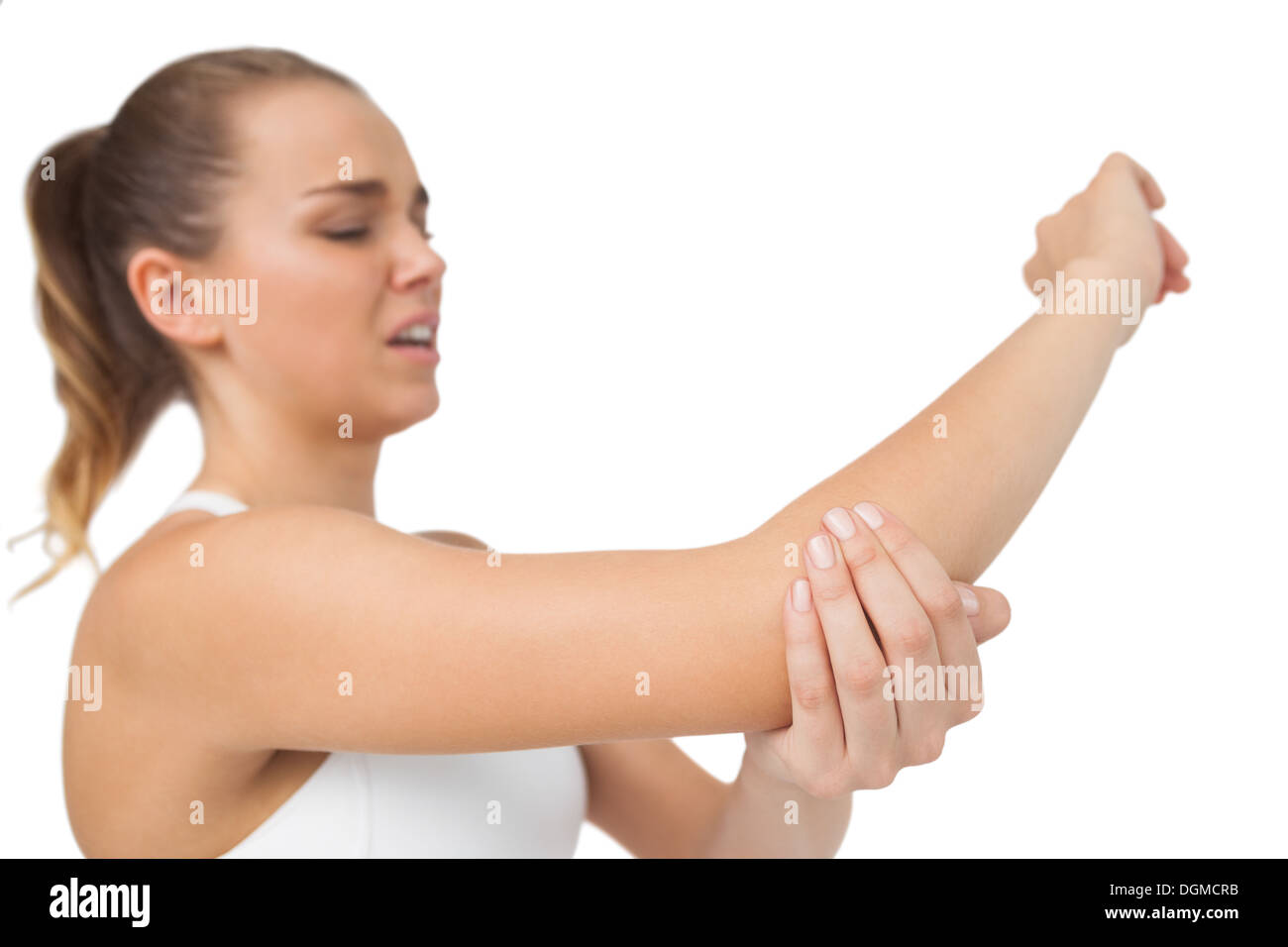 Suffering young woman touching her sore elbow Stock Photo