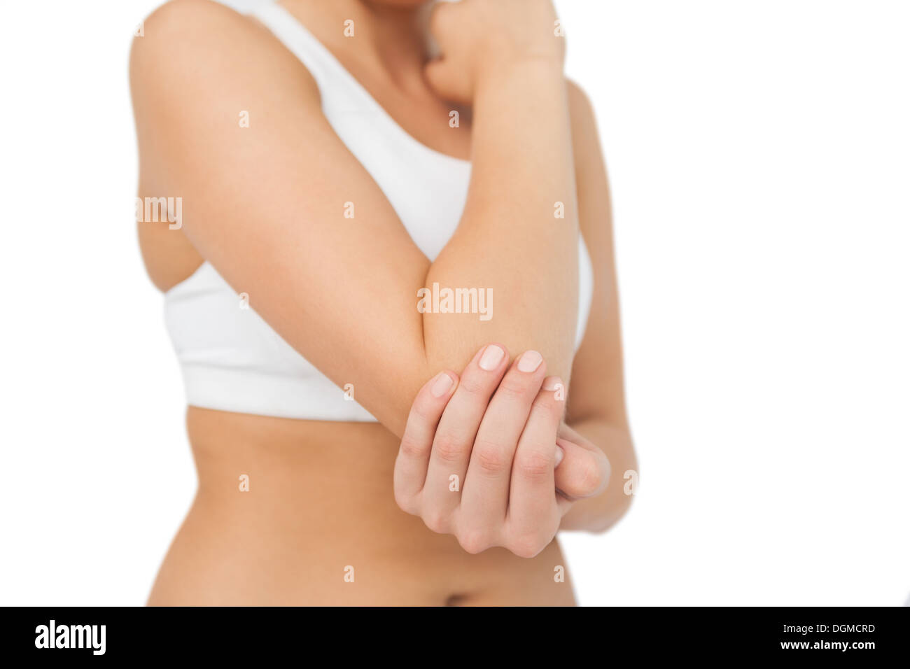Young sporty woman touching her sore elbow Stock Photo