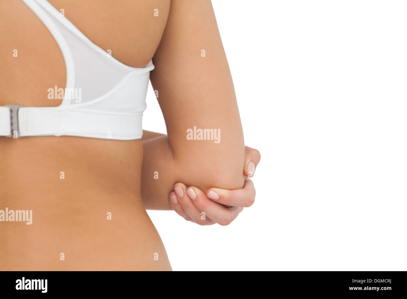 Rear view of young woman touching her injured elbow Stock Photo