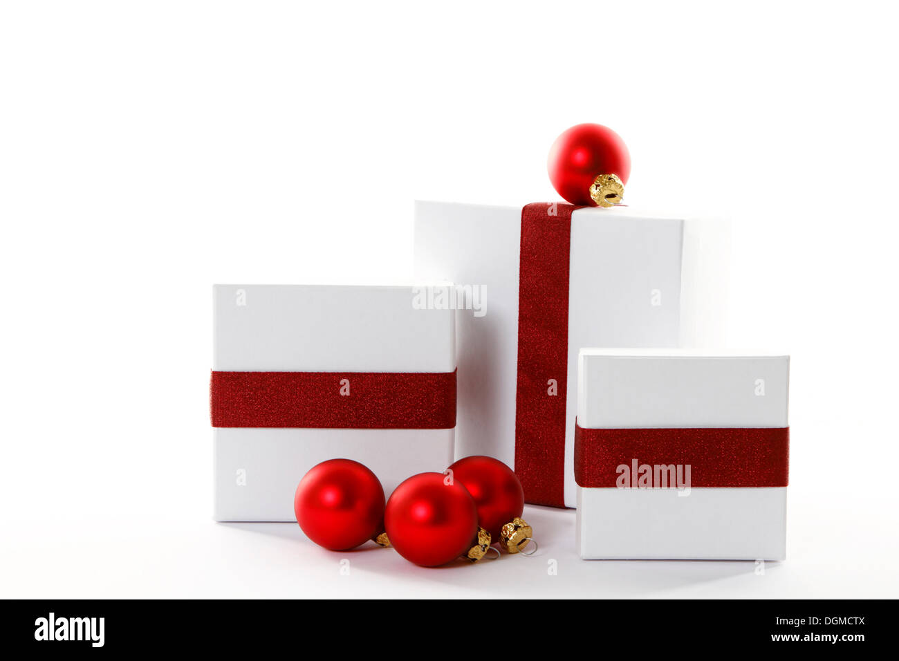 Red Christmas baubles and presents with red ribbons Stock Photo