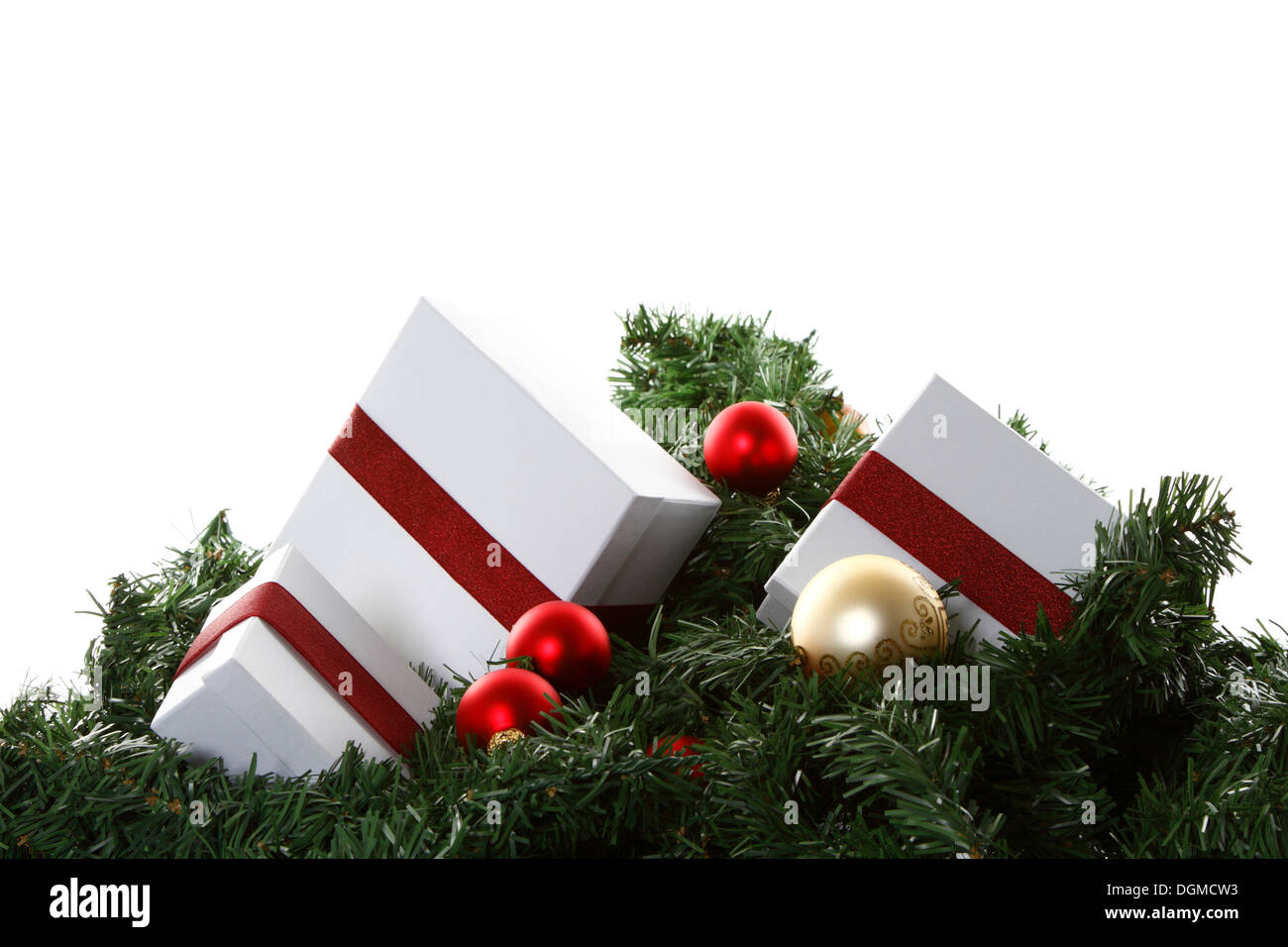 Christmas presents and baubles on artificial fir sprigs Stock Photo