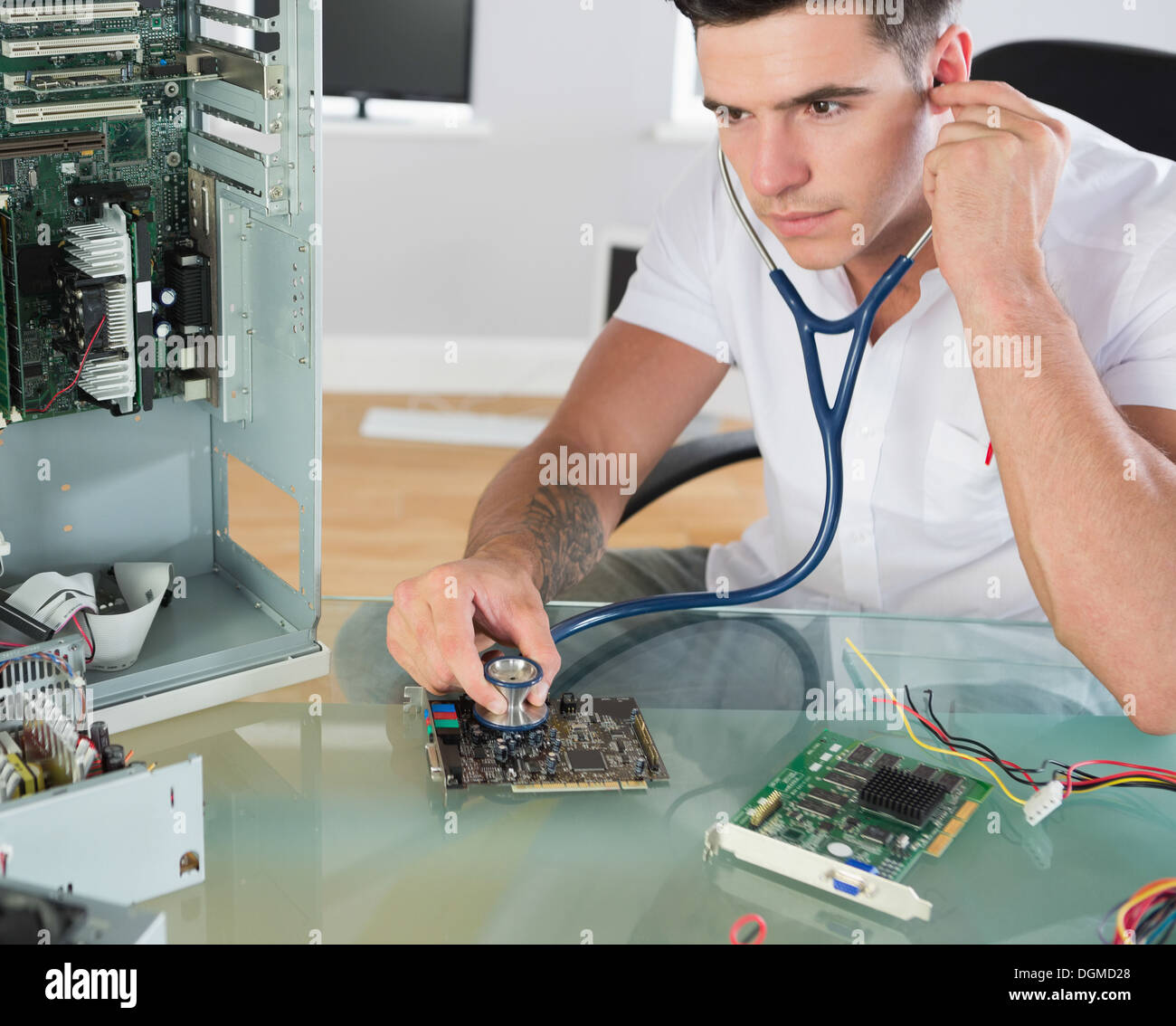 Handsome stern computer engineer holding stethoscope Stock Photo