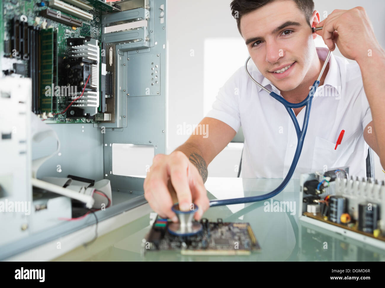 Handsome happy computer engineer holding stethoscope Stock Photo - Alamy