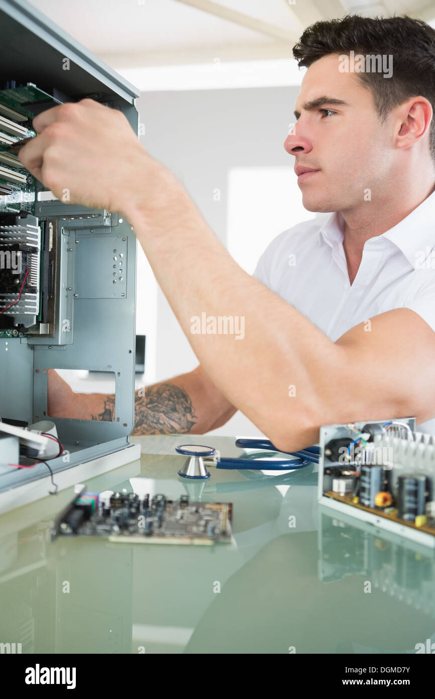 Handsome stern computer engineer working at open computer Stock Photo ...