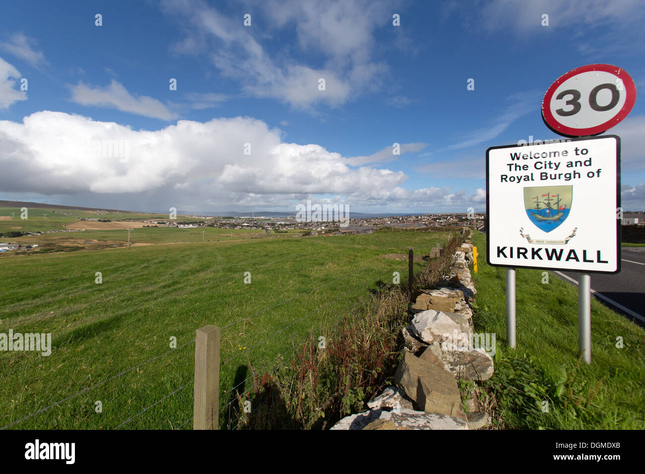 Islands of Orkney, Scotland. Kirkwall town boundary signpost on the A961 road, with Kirkwall in the background. Stock Photo