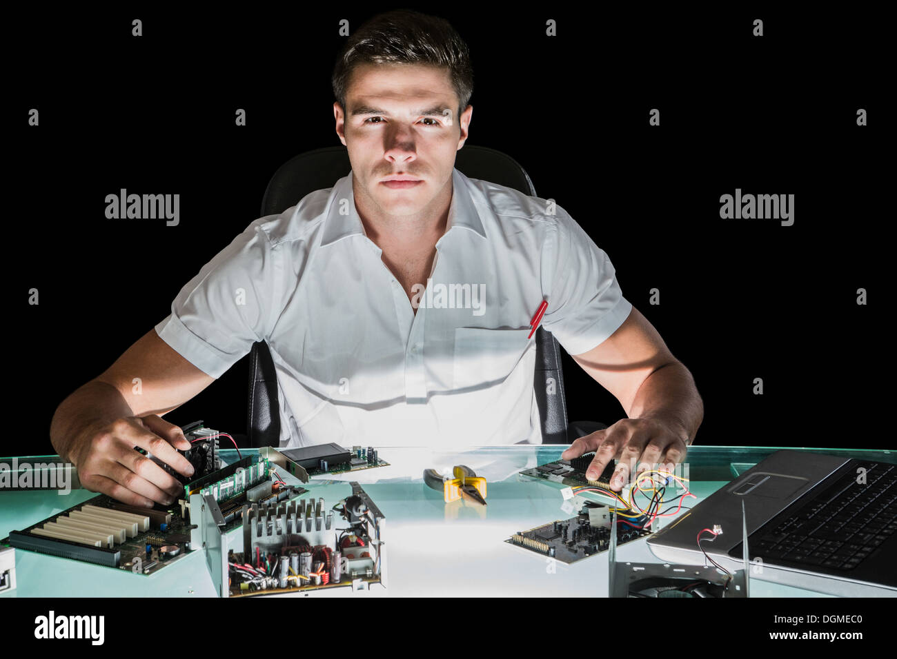 Handsome stern computer engineer working by night Stock Photo