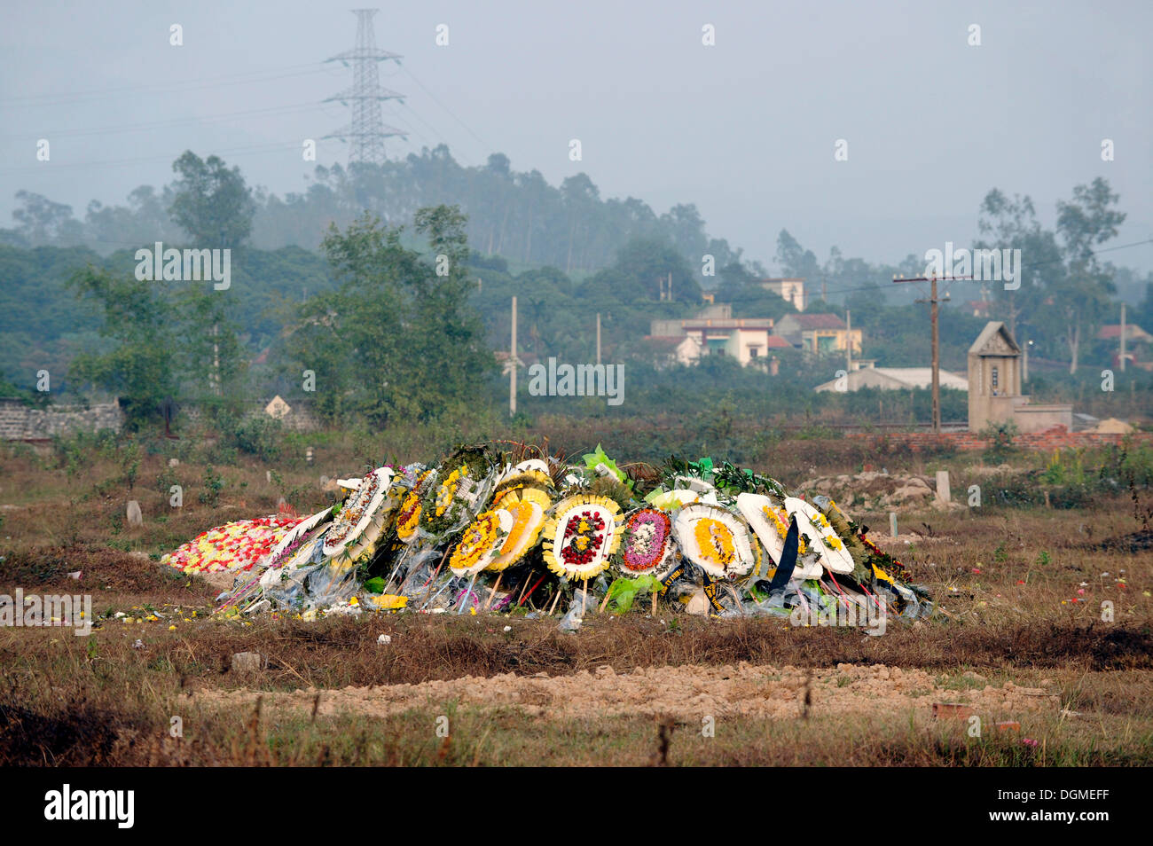 Fresh burial site with artificial flowers in a cemetery near Hanoi, North Vietnam, Vietnam, Southeast Asia, Asia Stock Photo