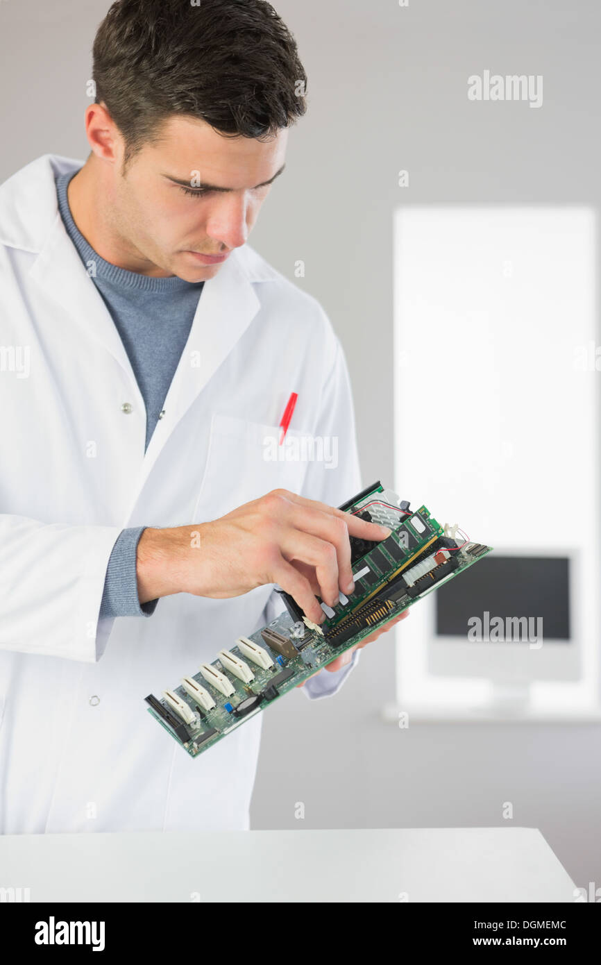 Attractive computer engineer holding hardware Stock Photo Alamy
