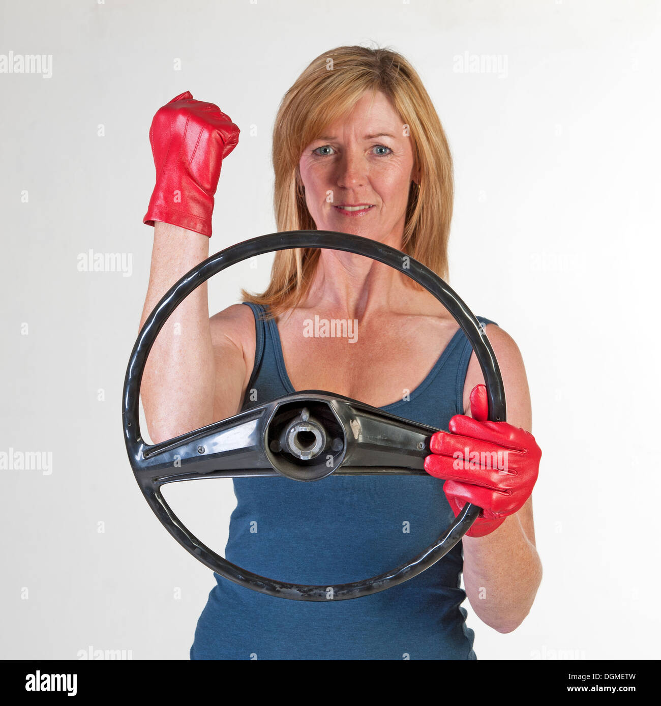 Woman driver at the steering wheel waving her fist Stock Photo Alamy