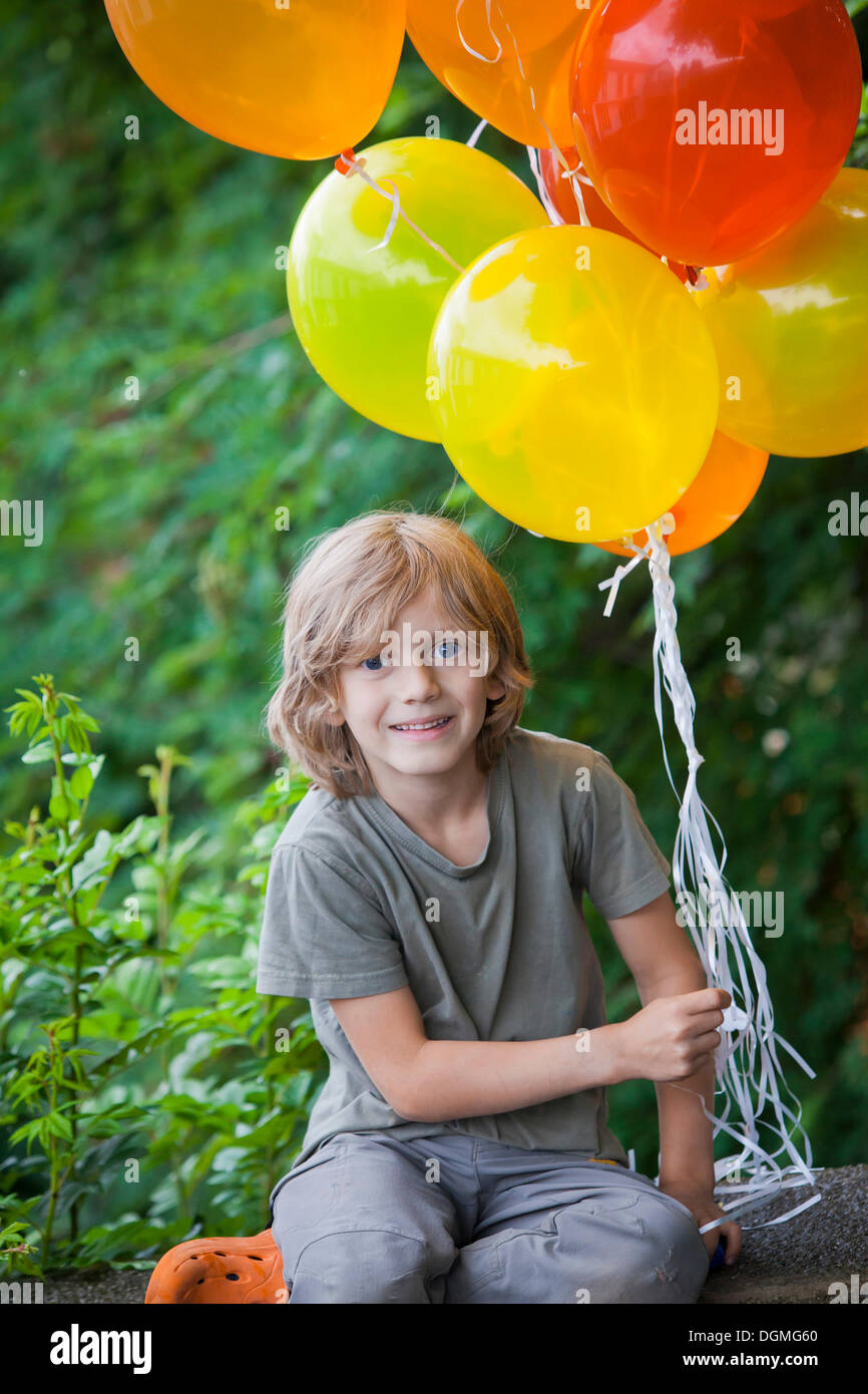 Boy, 6, with colourful balloons Stock Photo