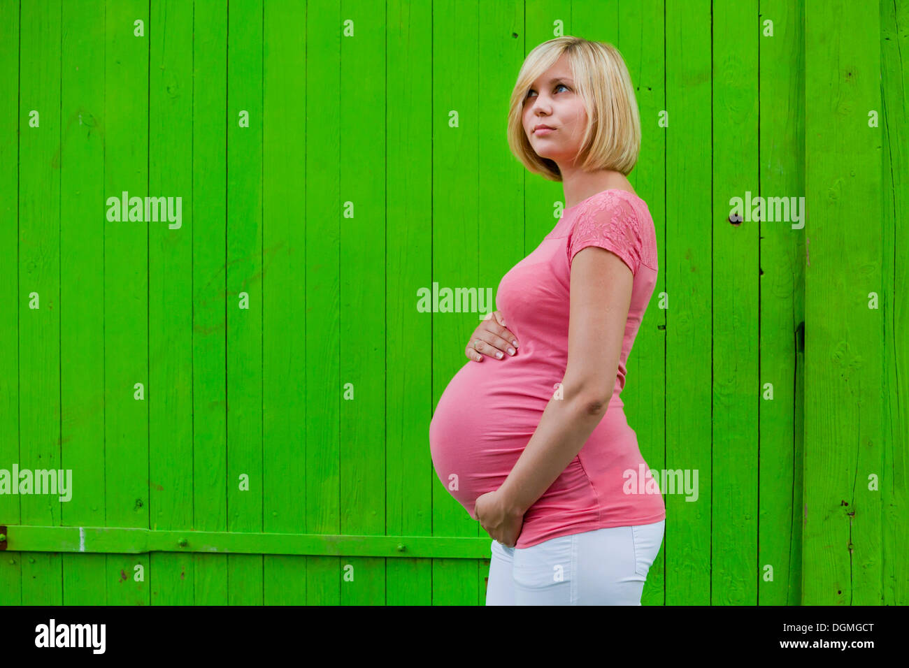 Young pregnant woman holding her belly Stock Photo