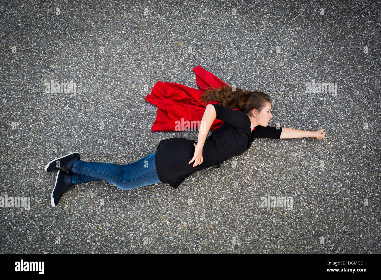 Young woman appearing to fly in a Superman or Supergirl position, taken from above Stock Photo