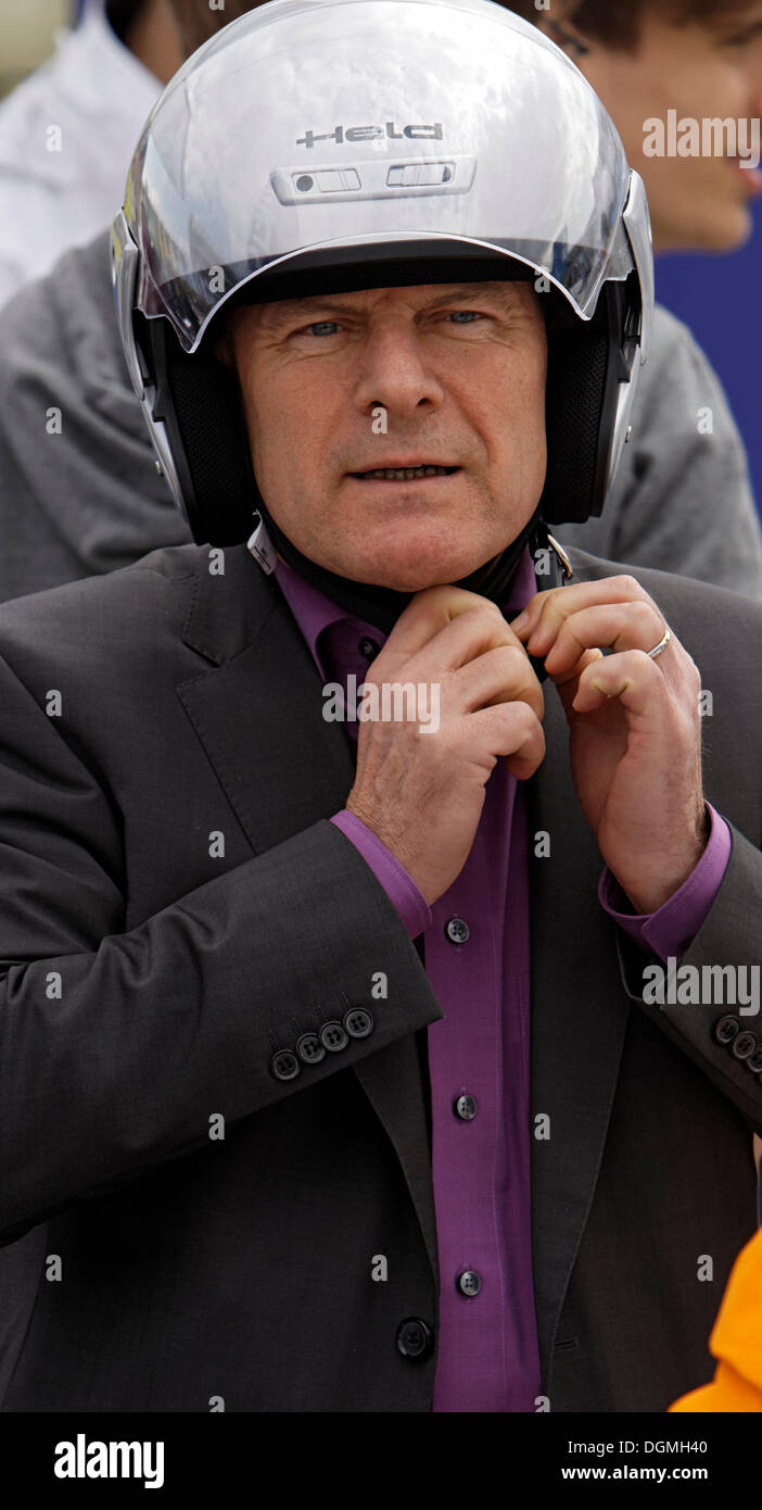 Winfried Hermann, Baden-Wuerttemberg's Minister of Transport and Infrastructure only riding a bicycle wearing a helmet Stock Photo
