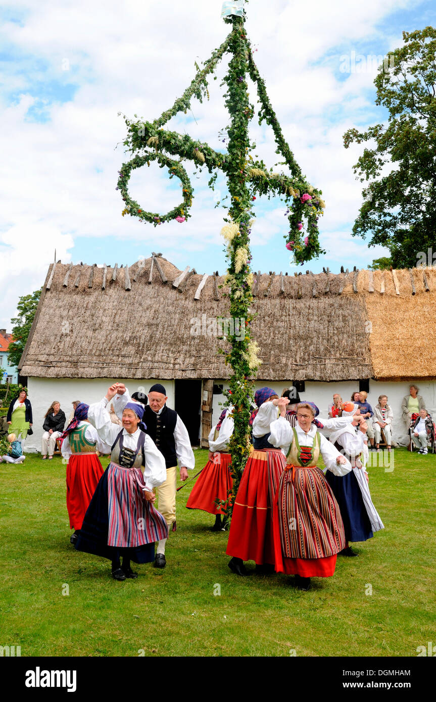 Dance around maypole, typical celebration of midsummer in Sweden