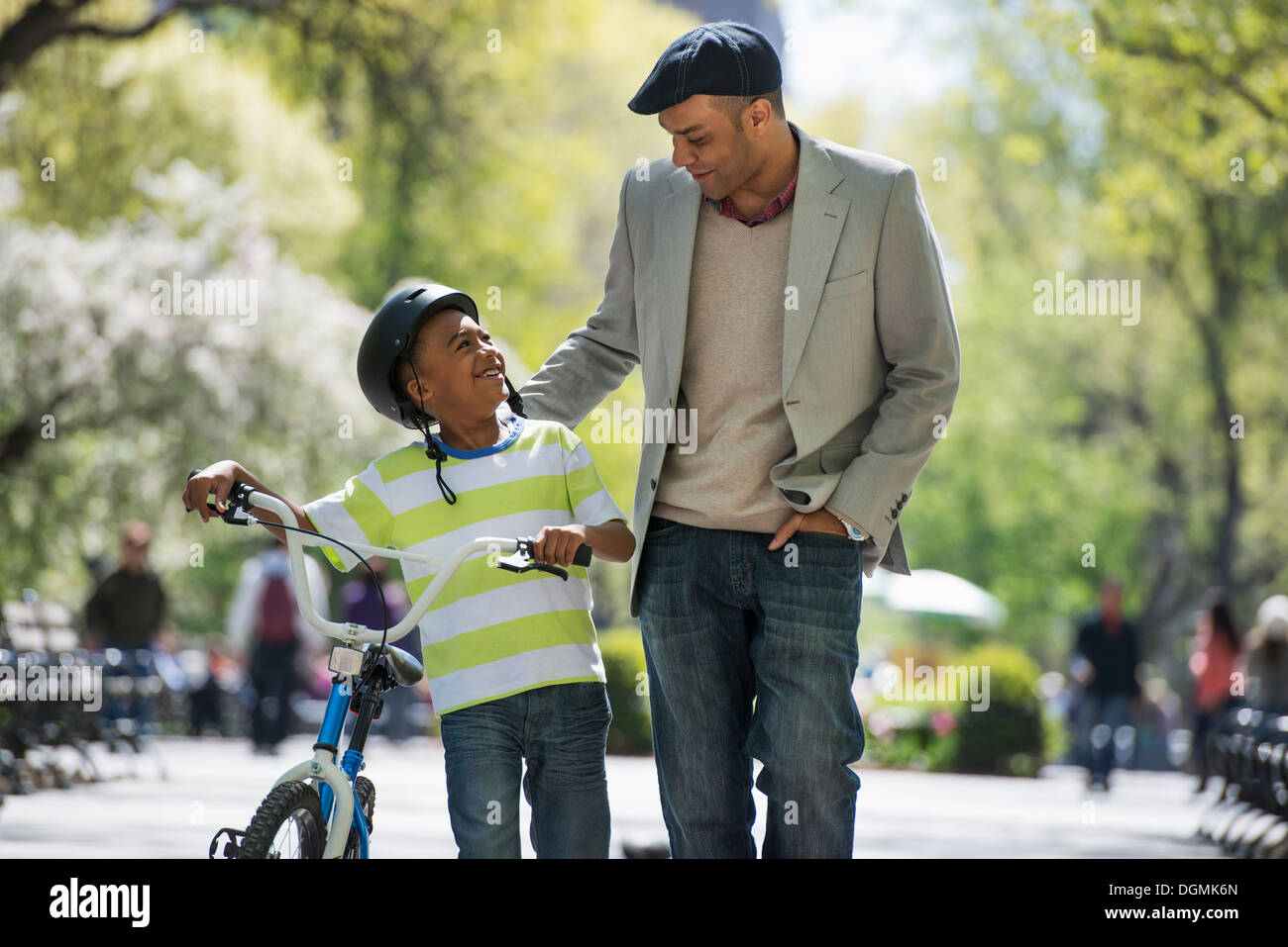 Bicycling and having fun. A father and son side by side. Stock Photo