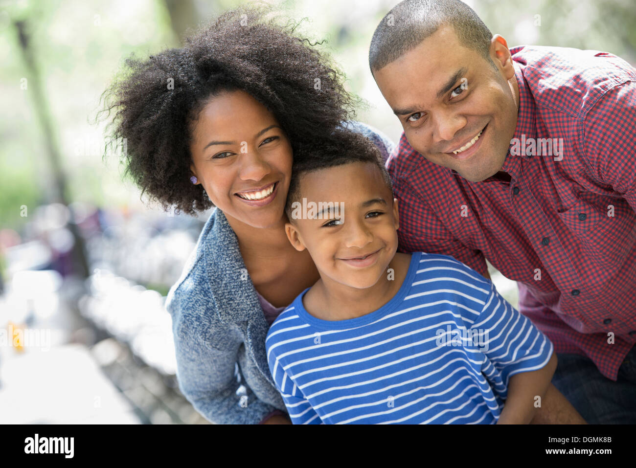 Two adults and a young boy taking photographs with a smart phone. Stock Photo
