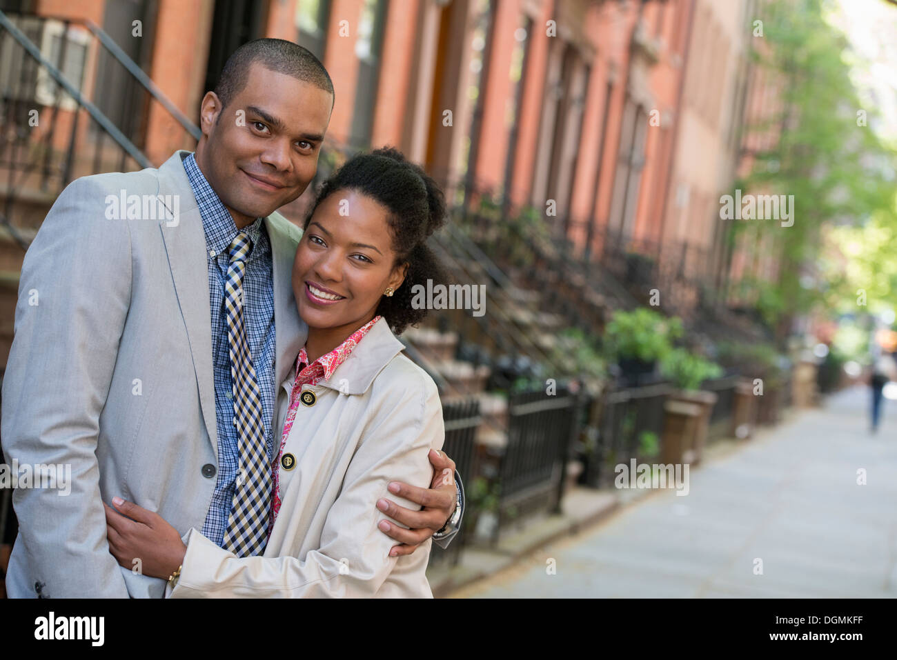 A couple standing side by side on a city street. Stock Photo