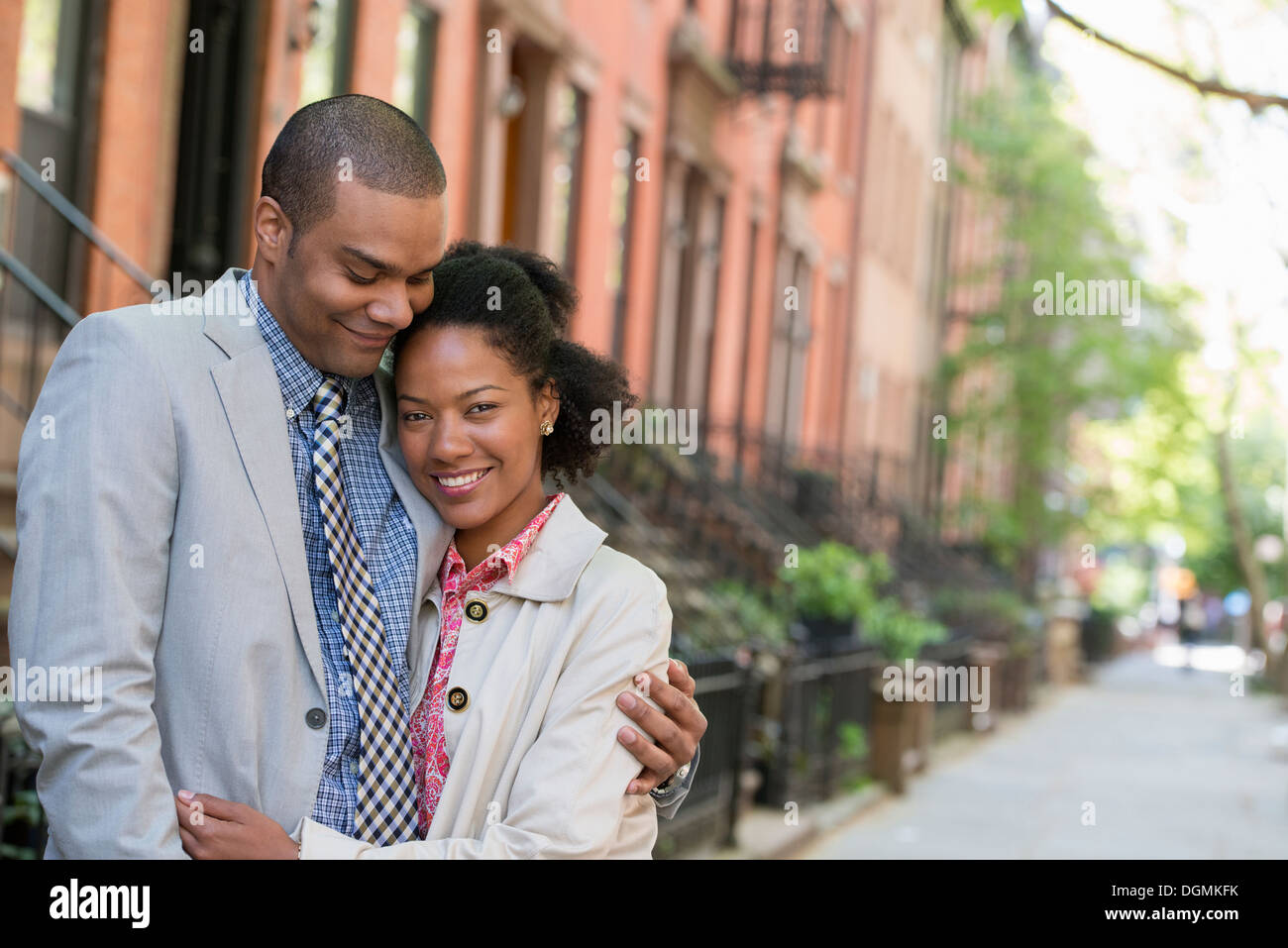 A couple standing side by side on a city street. Stock Photo