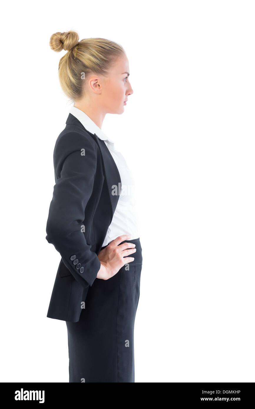 Cute businesswoman posing with hands on hips Stock Photo