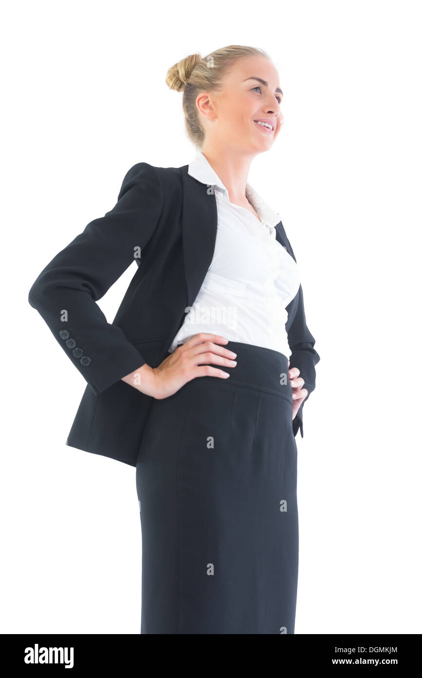 Low angle view of happy young businesswoman posing with hands on hips Stock Photo