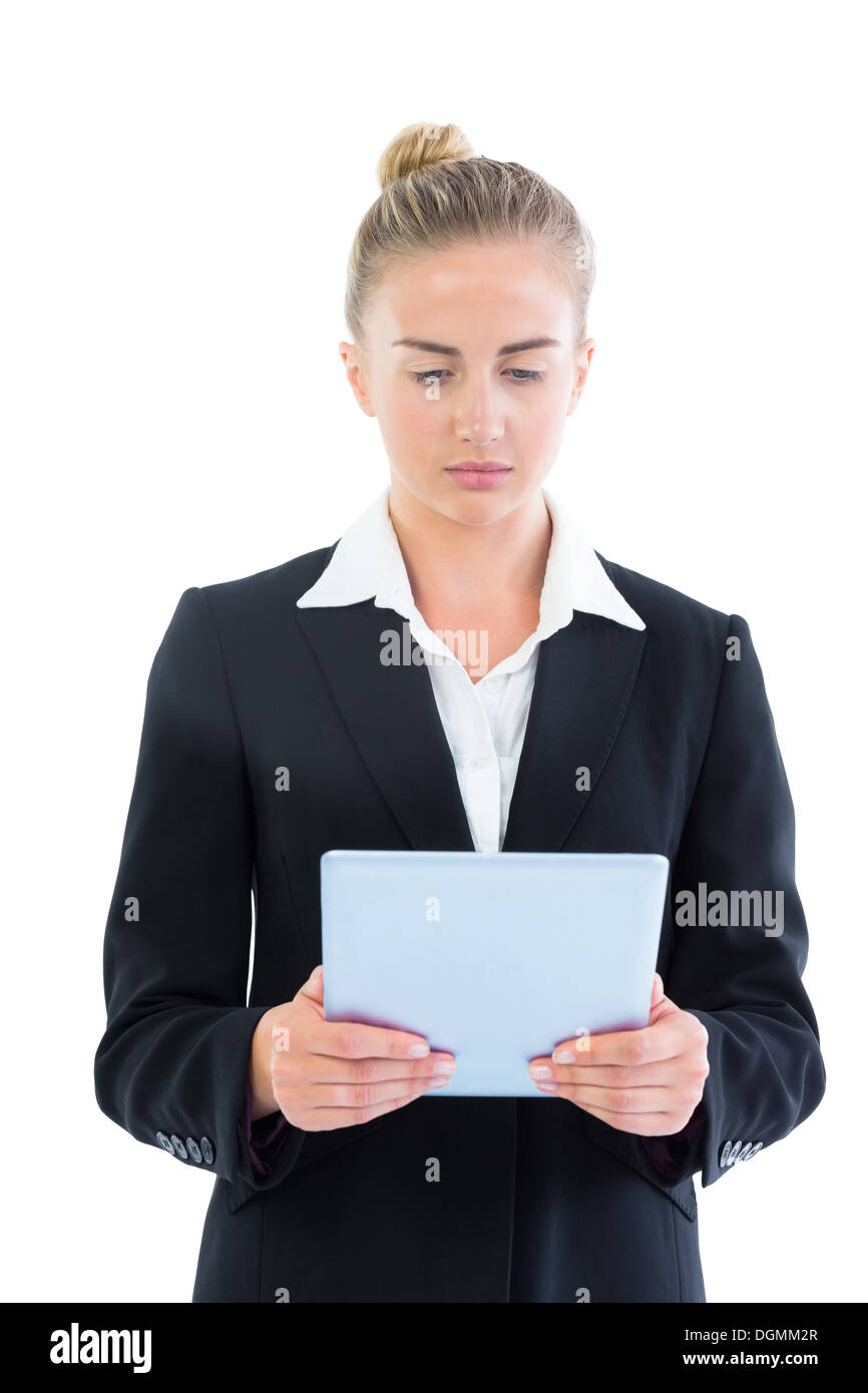 Profile view of concentrated young businesswoman using her tablet Stock Photo