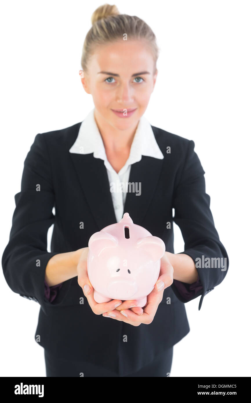Cute businesswoman holding a piggy bank Stock Photo - Alamy