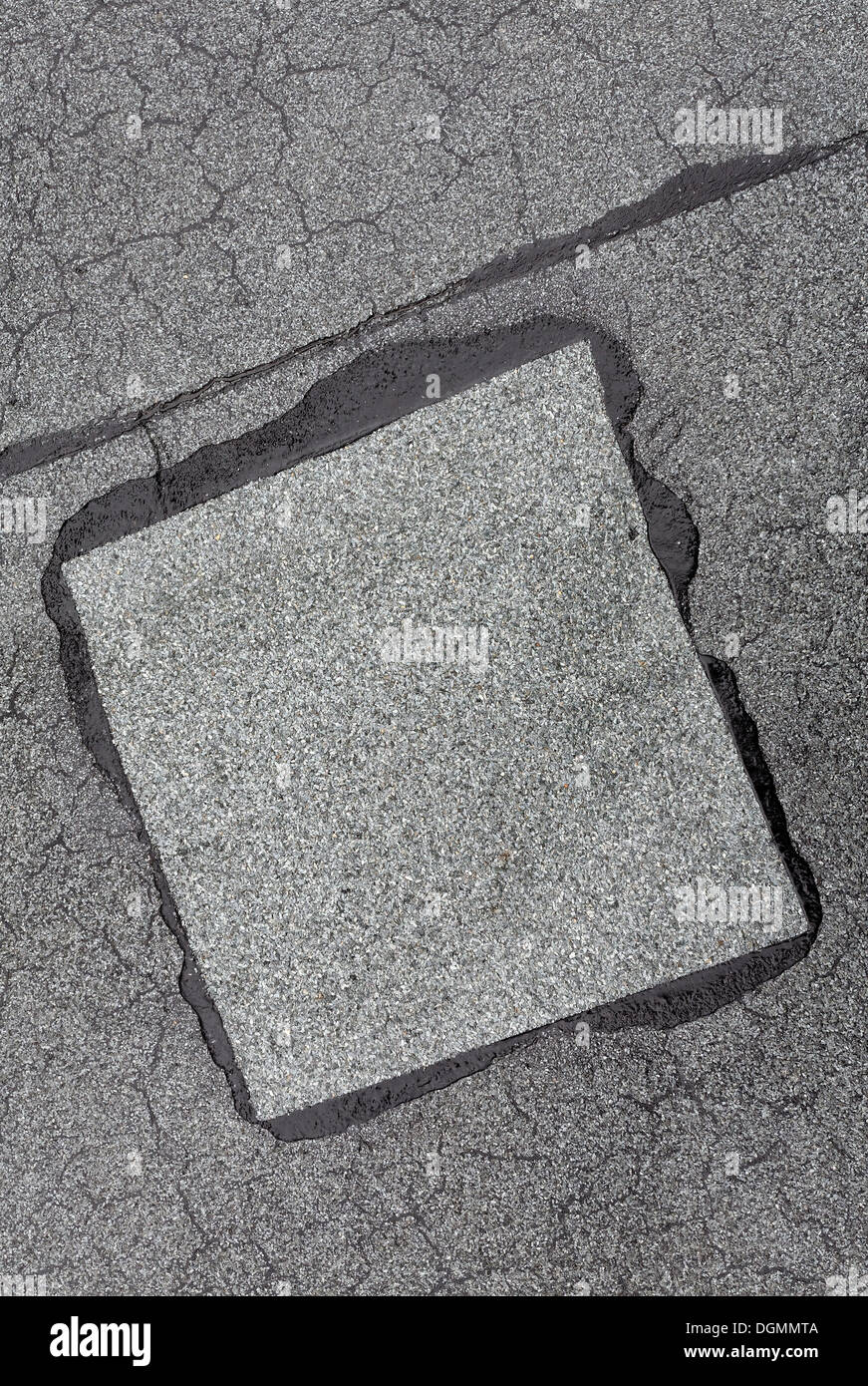Patched-up, repaired area on a roof made of roofing felt Stock Photo