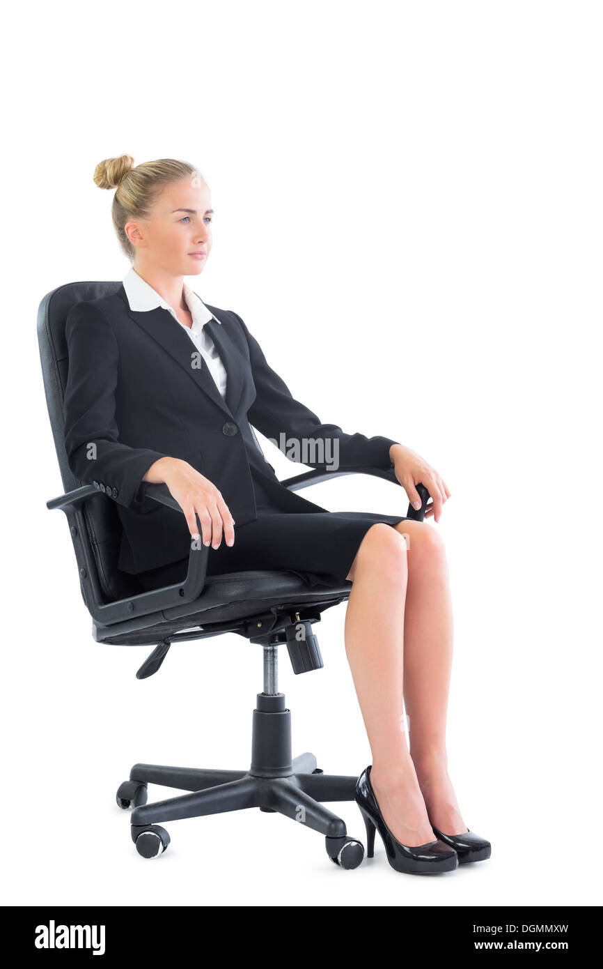 Side view of serious businesswoman sitting on an office chair Stock Photo