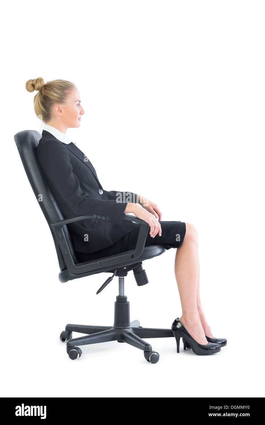 Side view of serious businesswoman sitting on an office chair Stock Photo