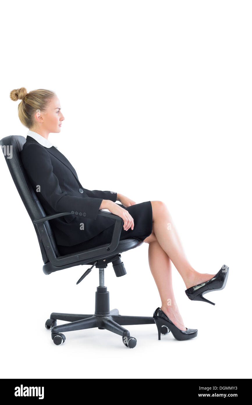 Side view of attractive serious businesswoman sitting on an office chair Stock Photo