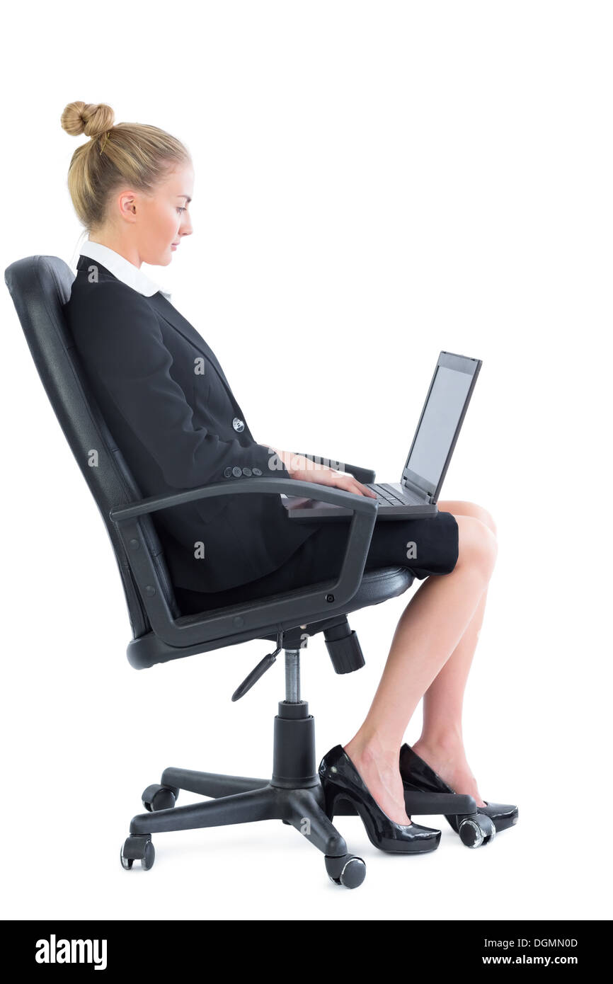 Side view of attractive blonde businesswoman sitting on an office chair Stock Photo