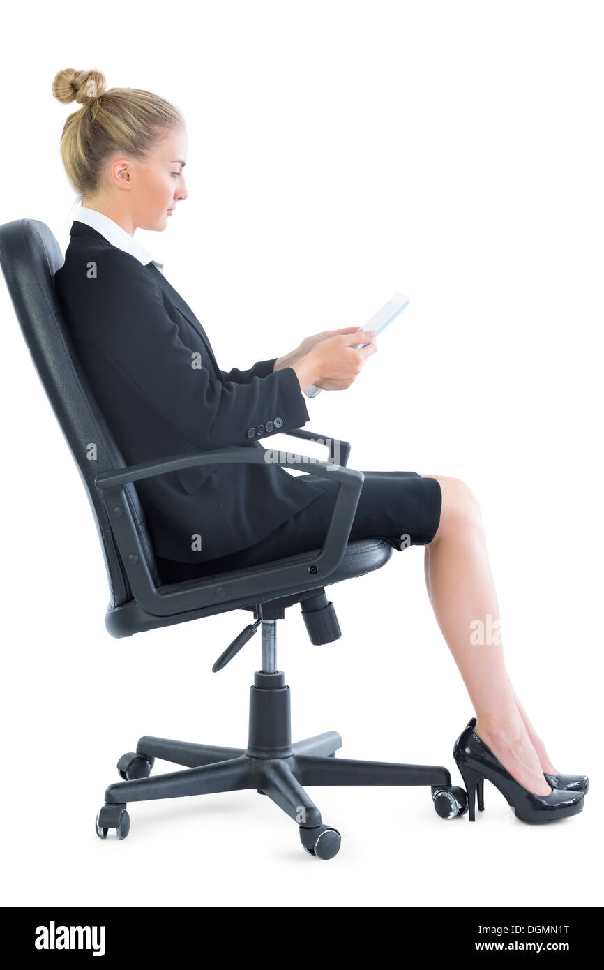Side view of attractive young businesswoman sitting on an office chair Stock Photo