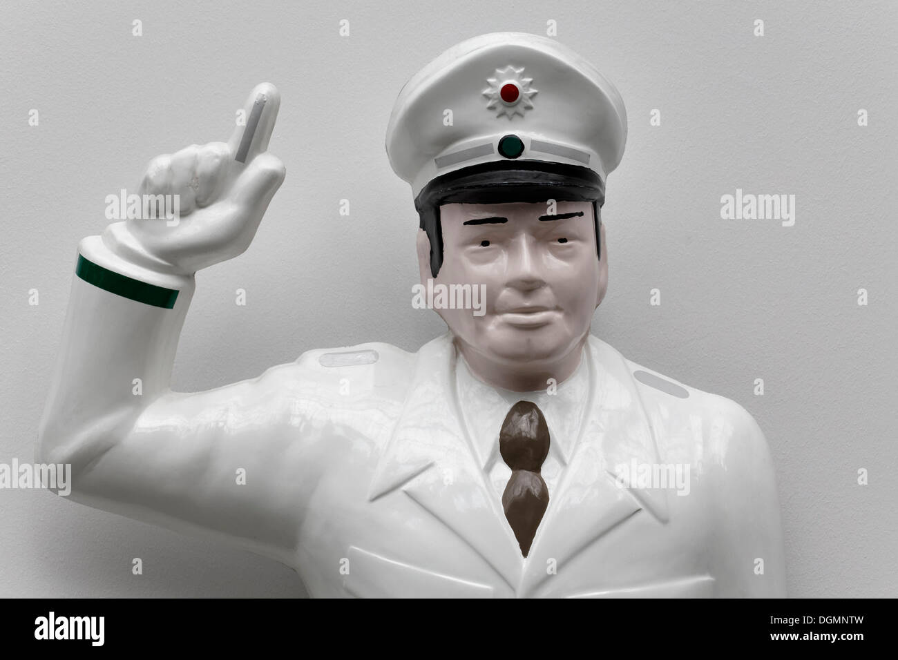 Traffic cop with a wagging finger, figure made of plastic Stock Photo