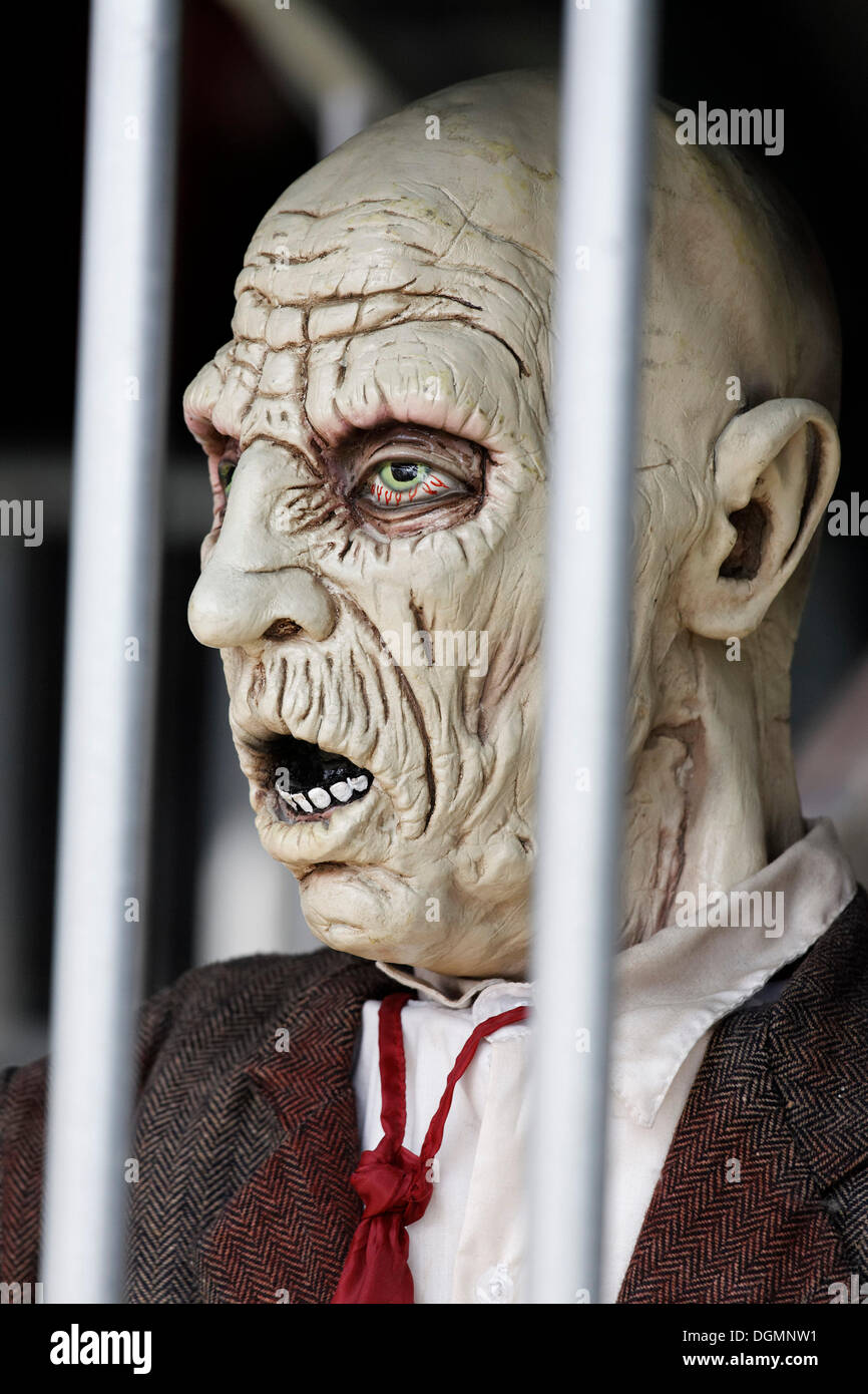 Man behind bars, desperate face, haunted house figure Stock Photo