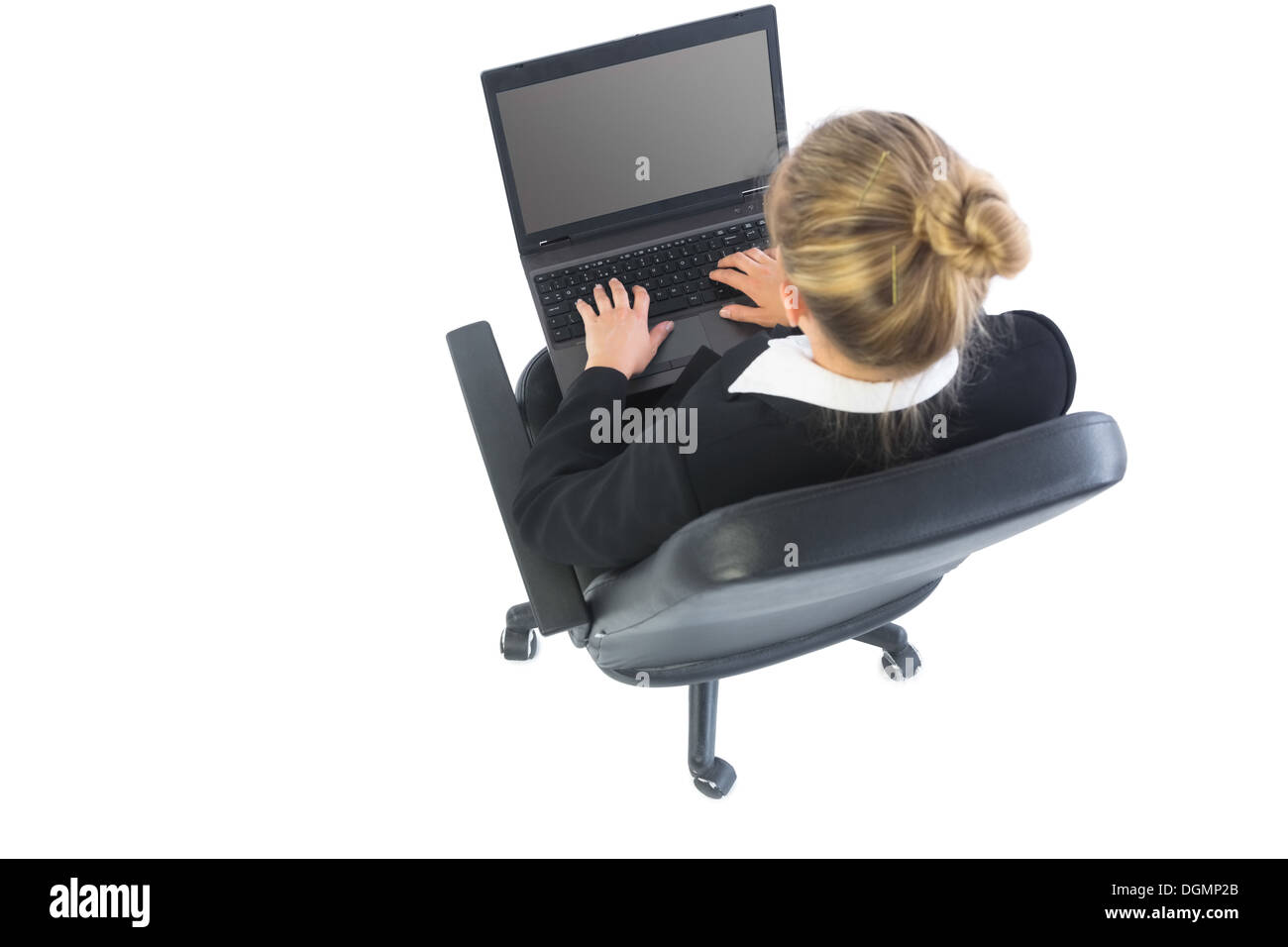 Rear view of blonde businesswoman sitting in swivel chair using laptop Stock Photo