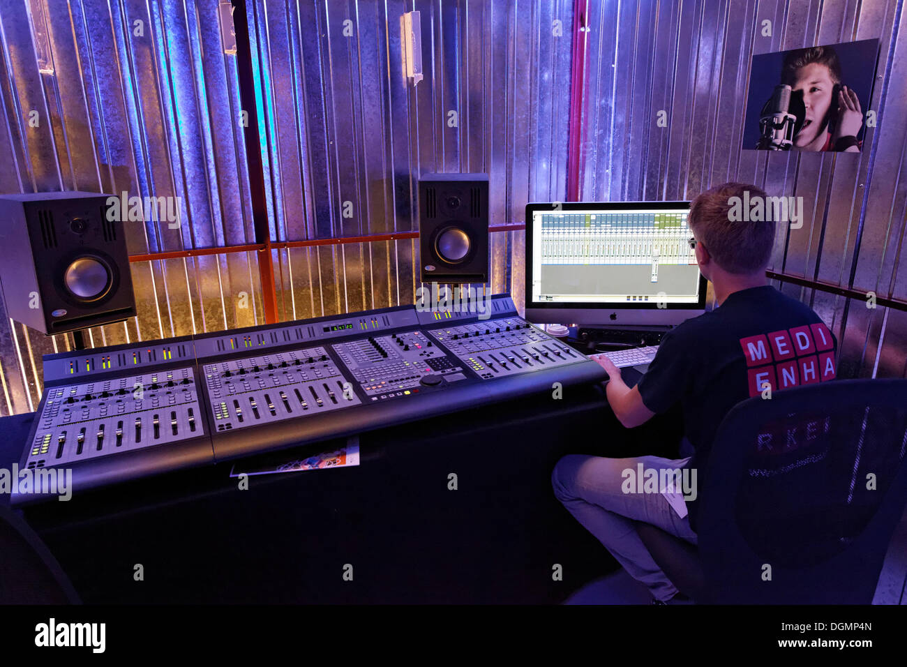 Sound engineer at the mixing desk in a recording studio, music production demonstration of the SAE Institute, IdeenPark 2012, Stock Photo