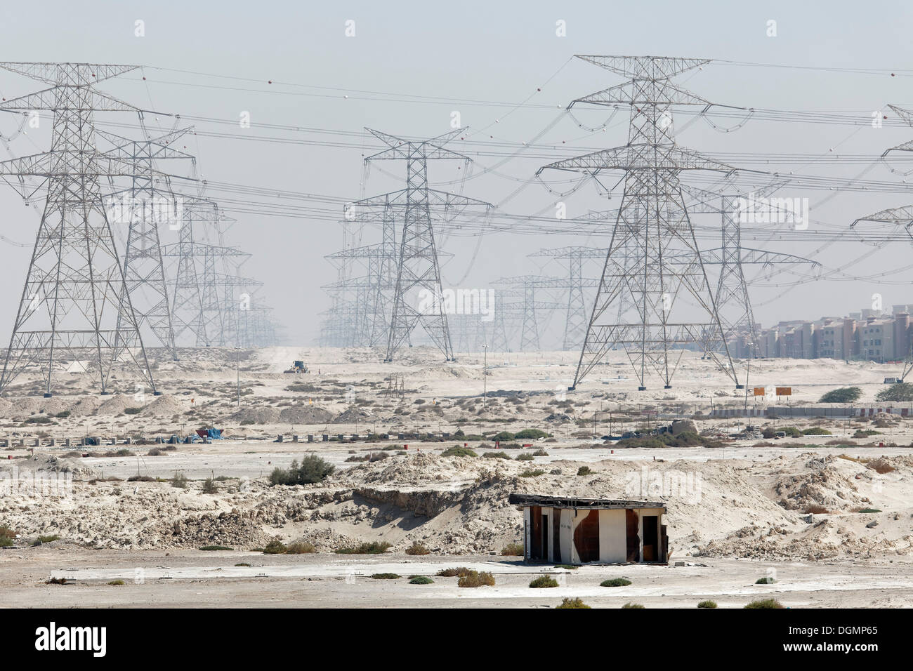 Barren land with electricity transmission pylons, urban development area, Nakheel Harbour, Dubai, United Arab Emirates Stock Photo