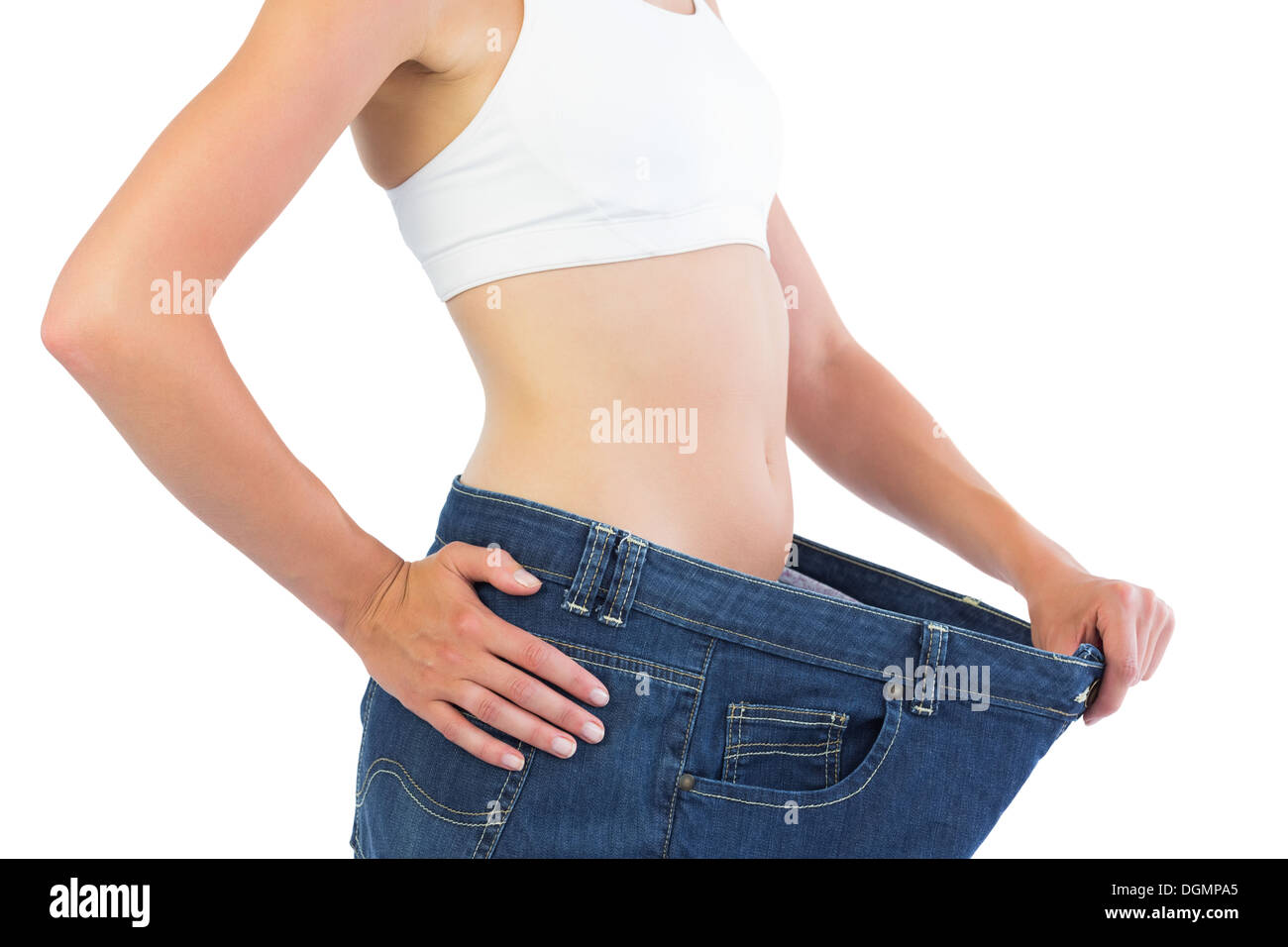Close up of confident slim blonde wearing too big trousers Stock Photo