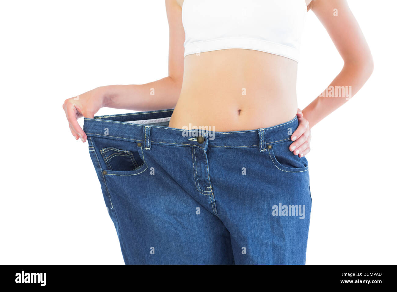 Close up of confident slender blonde wearing too big trousers Stock Photo