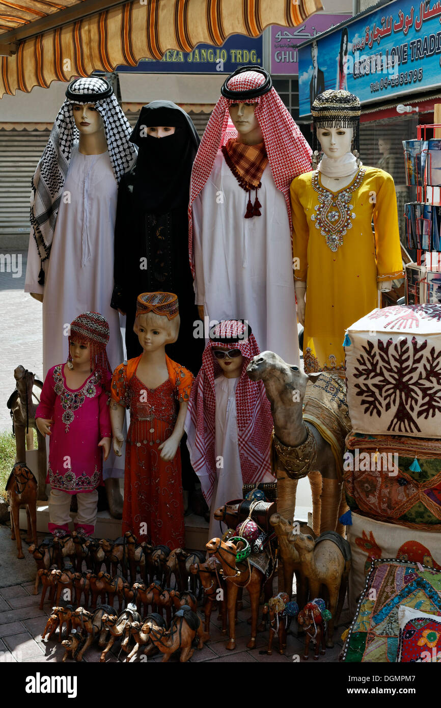 Mannequins wearing traditional Arabic clothing for sale, for women, men and children, Deira, Old Souk, Dubai Stock Photo