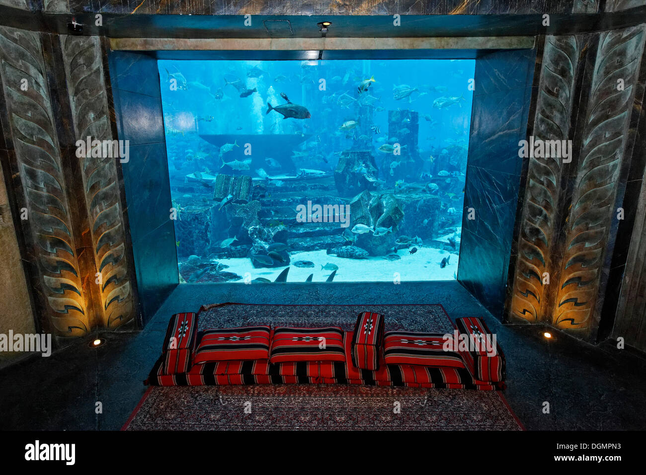 Seat in front of an aquarium in The Lost Chambers, a theme park based