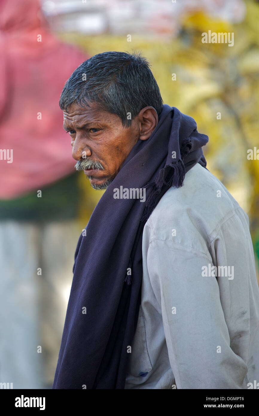 Shot taken of a distinguished looking Indian man, waiting to cross a busy street in the Delhi suburb of Saket, India. Stock Photo