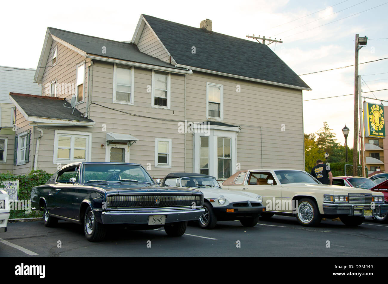 1966 Dodge Charger, Mg and classic Cadillac in front of house in New Jersey, USA. Stock Photo