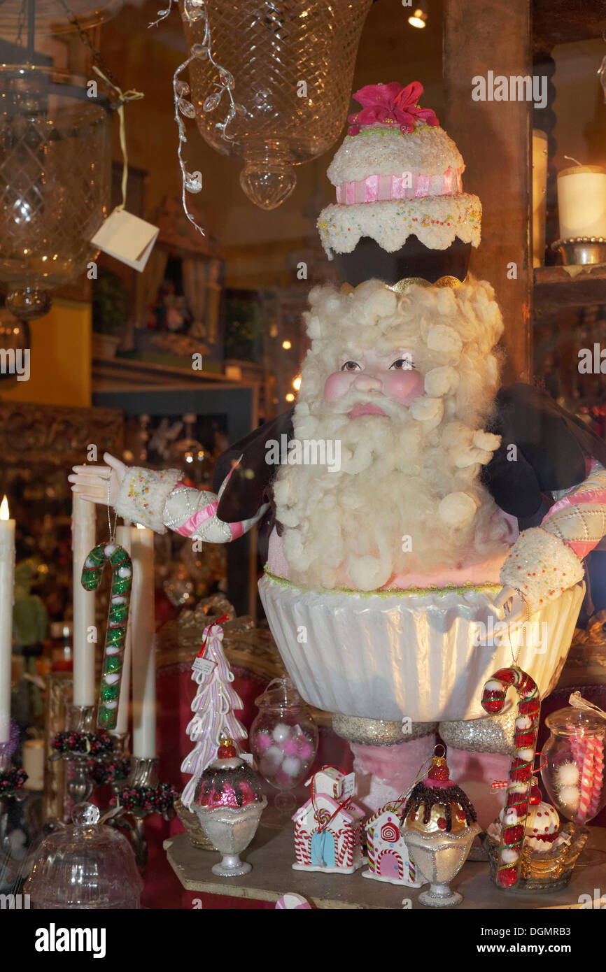 Santa Claus figure with a cake on its head, in a shop window, historic shopping arcade, Passage Jouffroy, Grands Boulevards Stock Photo