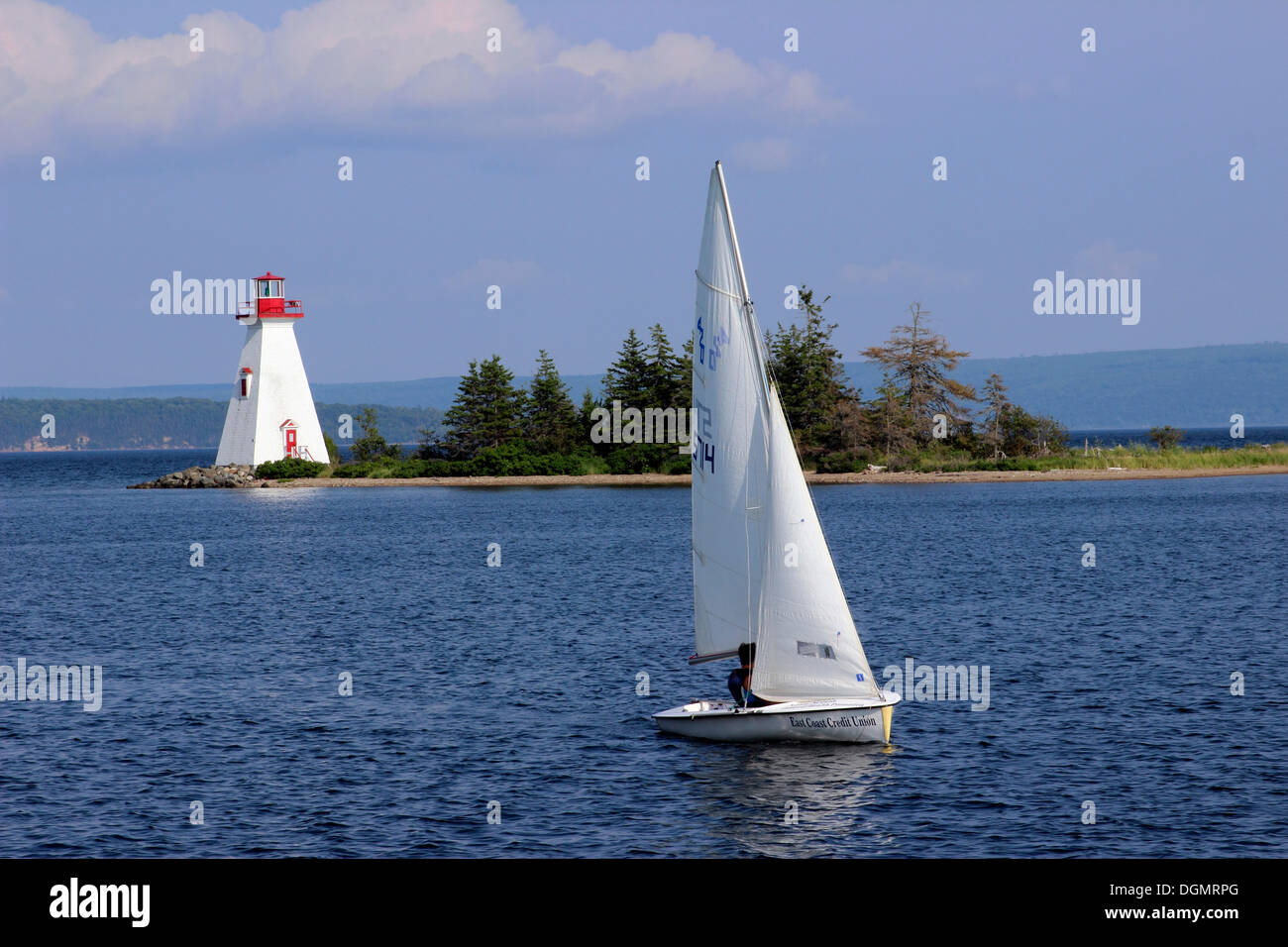Lighthouse with sloop sail boat, Bras d'Or Lake, Baddeck, Cape Breton, Nova Scotia, Canada Stock Photo